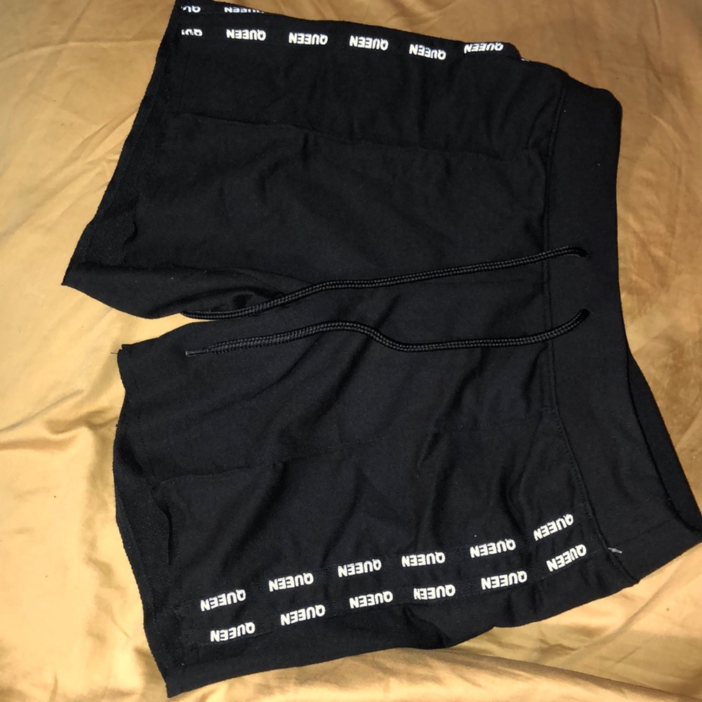 black shorts with white writing